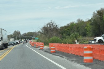 Setting up a temporary pedestrian pathway along the US 98 Bypass (2-15-2024 photo)