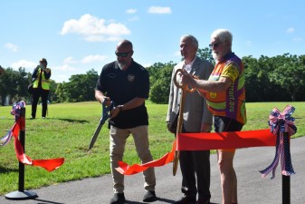 L to R: David Bailey (Brooksville Council Member), David Gwynn, P.E. (FDOT District Seven Secretary), and Jim McClean (West Central Florida CTST Vice Chair) cut the ceremonial ribbon to mark the trail completion (5.22.2024 photo)
